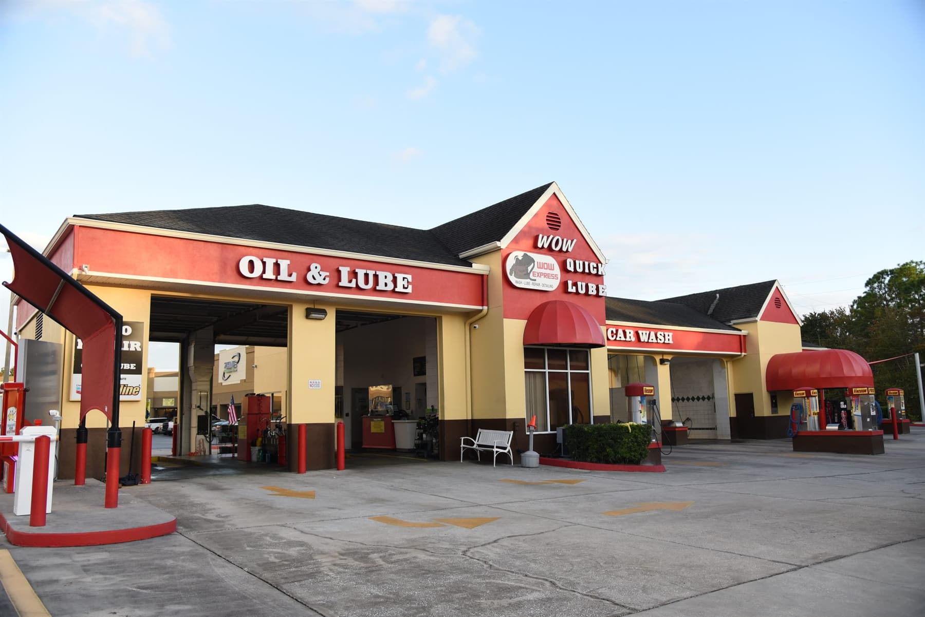 The Wow Express building in Trinity, FL — Oil & Lube bays, Wow Quick Lube tower, and Car Wash tunnel